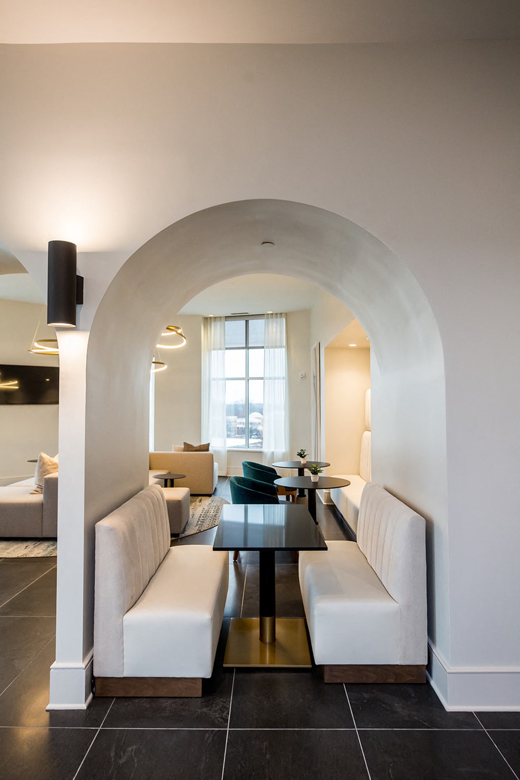 a living room with white couches and a black table