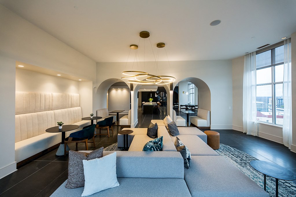 a living room with a large couch and tables