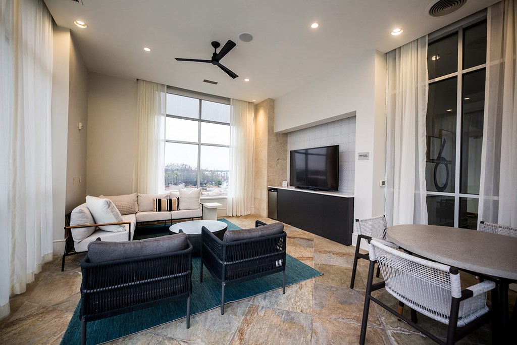a living room filled with furniture and a large window