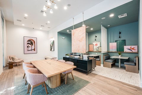 A modern dining room with a wooden table and chairs.