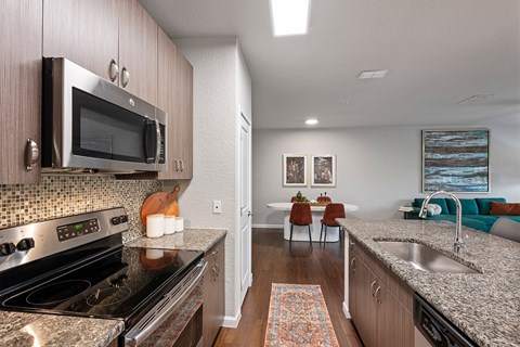 A kitchen with a stove top oven and microwave above it.