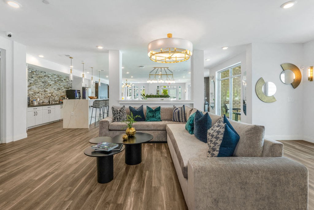 a living room filled with furniture and a large window