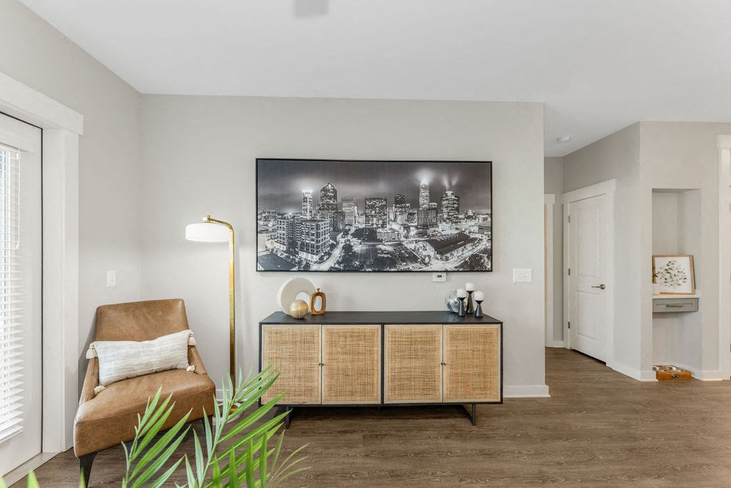 a black and white photo of the chicago skyline hangs on the wall of a living room