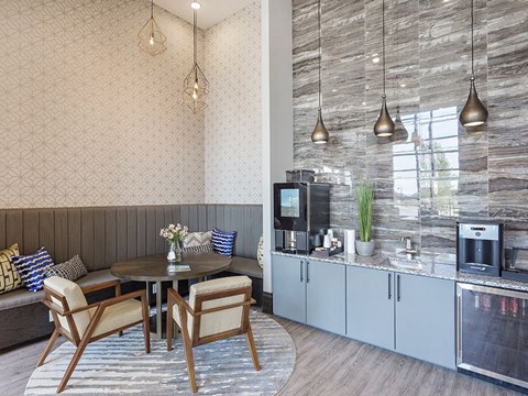A modern kitchen with a dining table and chairs.