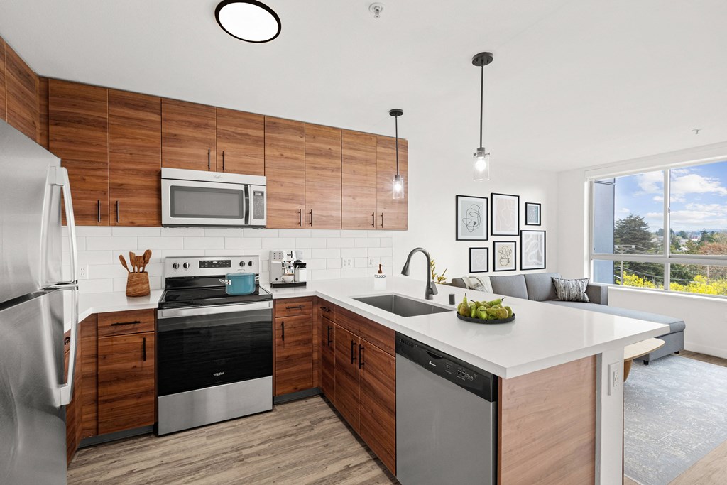a kitchen with white countertops and wooden cabinets