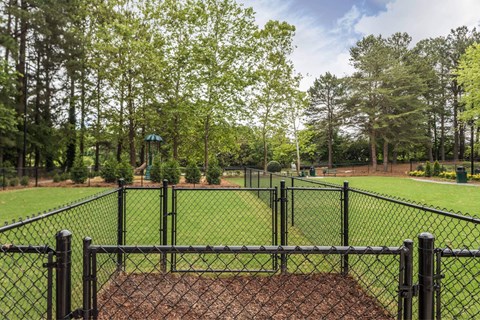 A black fence surrounds a baseball diamond.
