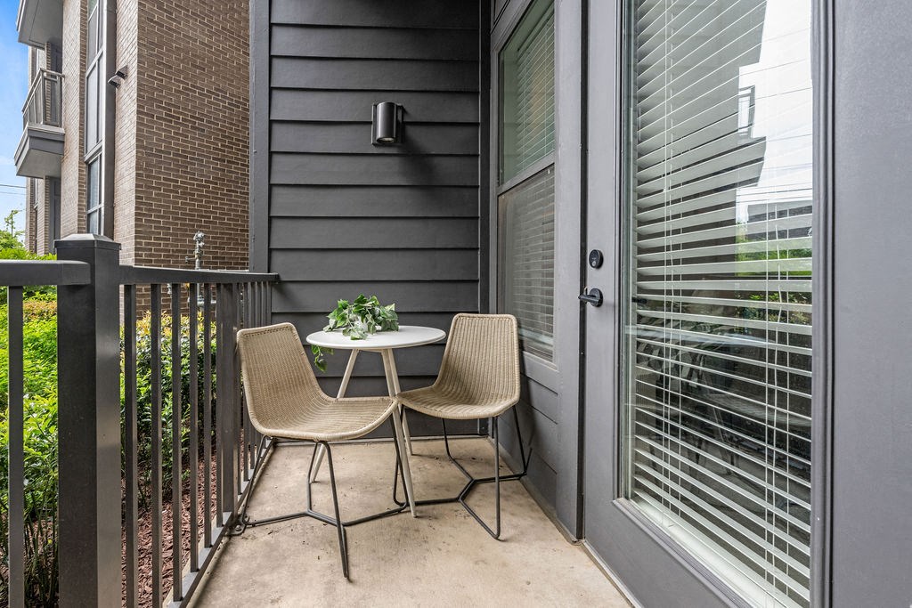 A patio with a table and two chairs.