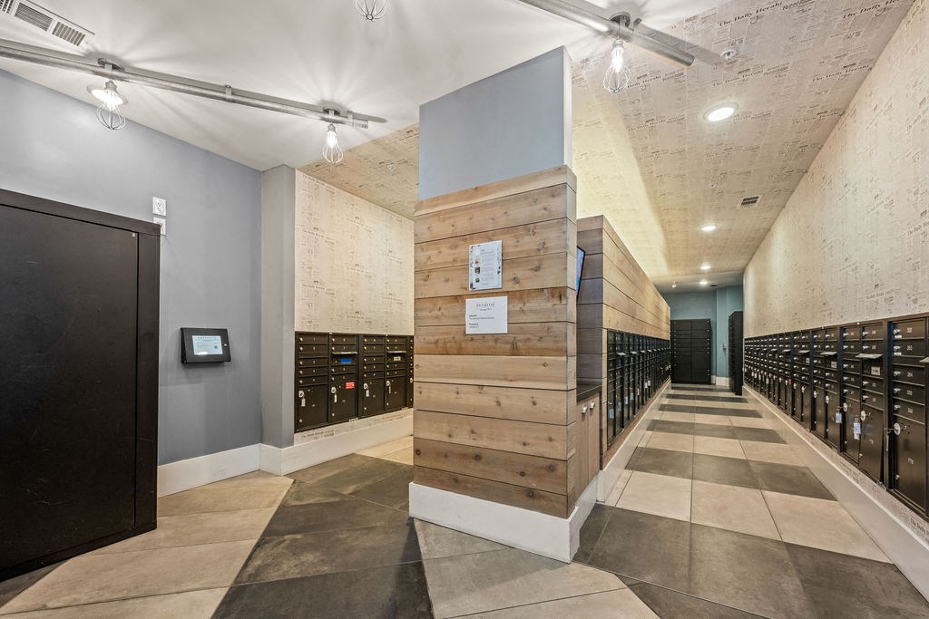 A long hallway with a wooden partition in the middle.