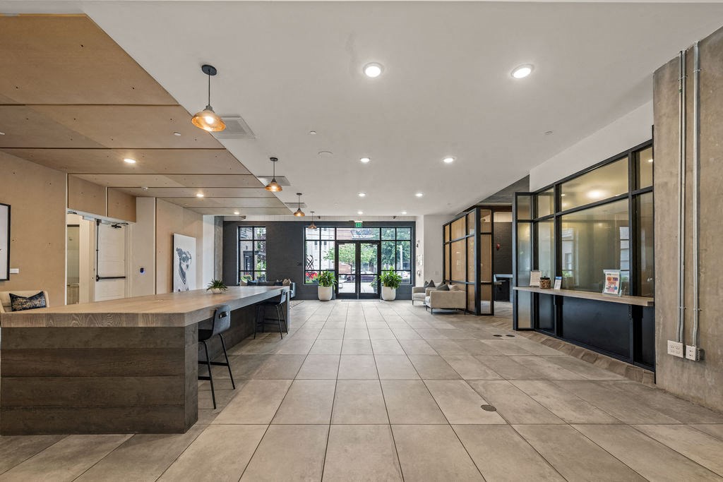 A spacious office lobby with a reception desk and seating area.