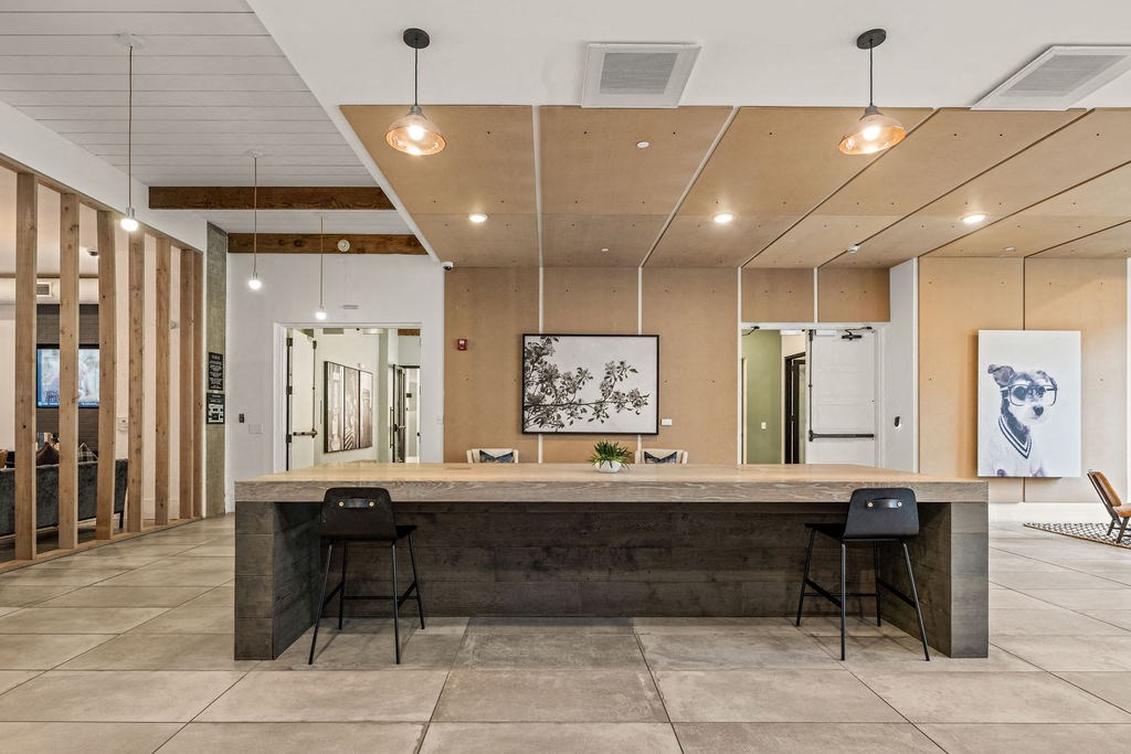 A modern office space with a long reception desk and two chairs.