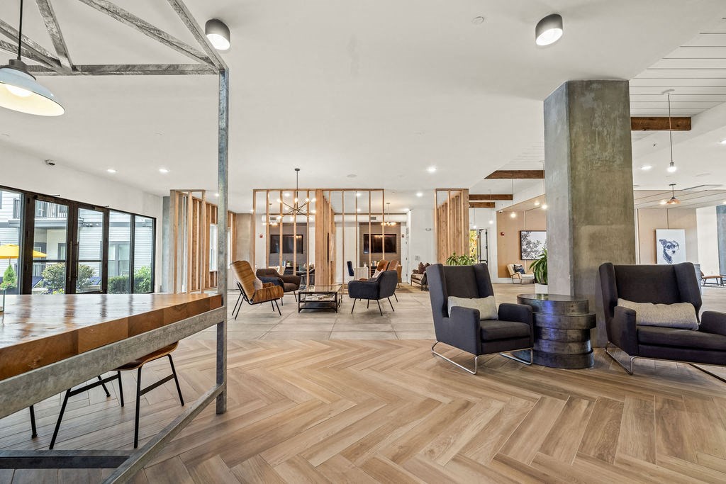 A modern living room with wooden floors and furniture.