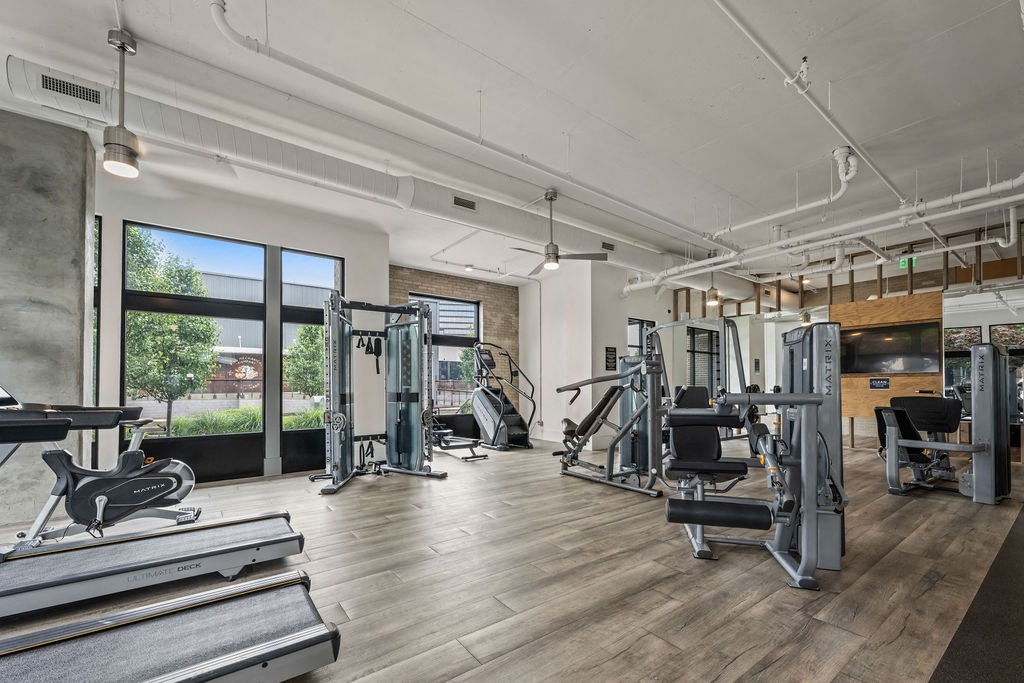 A gym with treadmills, weights, and exercise equipment.