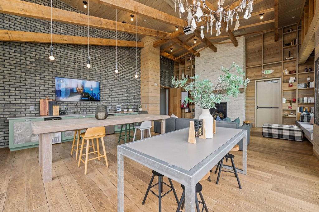 A modern kitchen with a dining table and chairs.