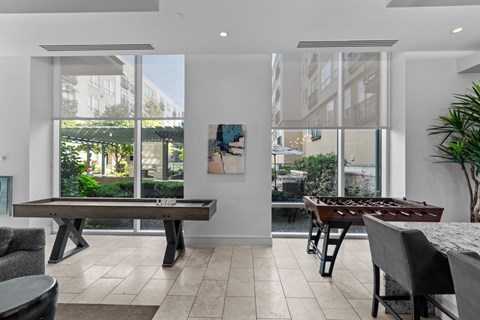 a game room with a foosball table and a pool table