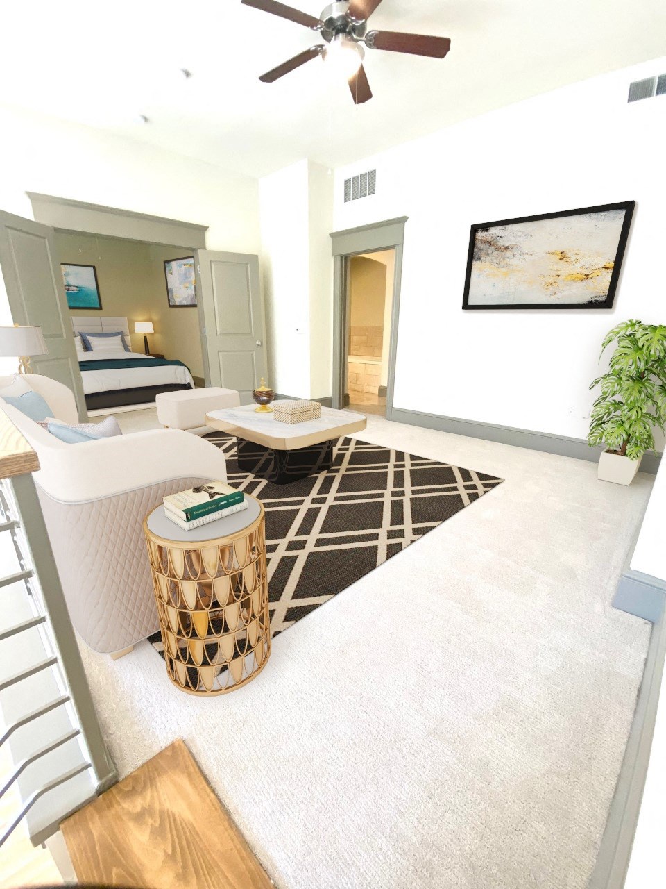 a living room with white furniture and a brown and white rug