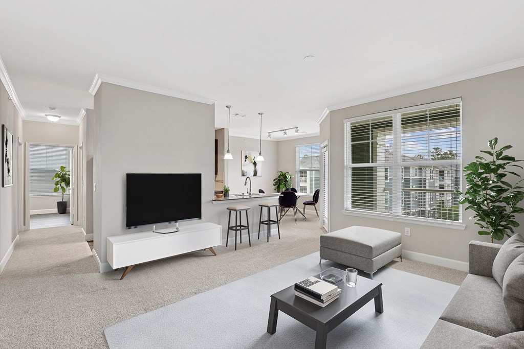 A modern living room with a flat screen TV and a fireplace.