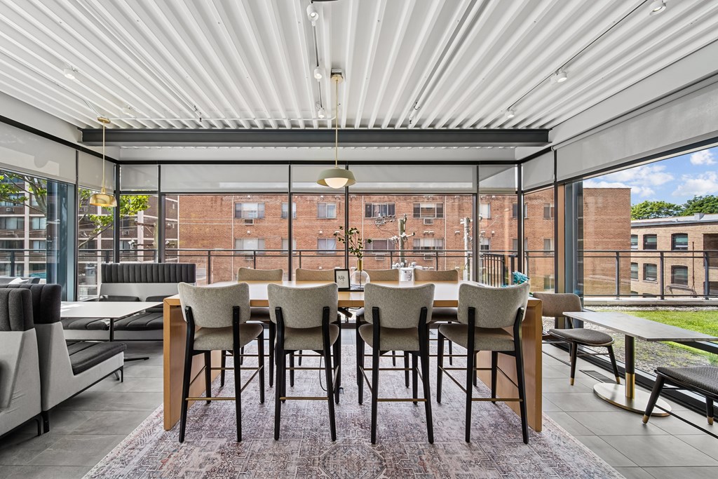 A dining table with chairs is set up on a patio.
