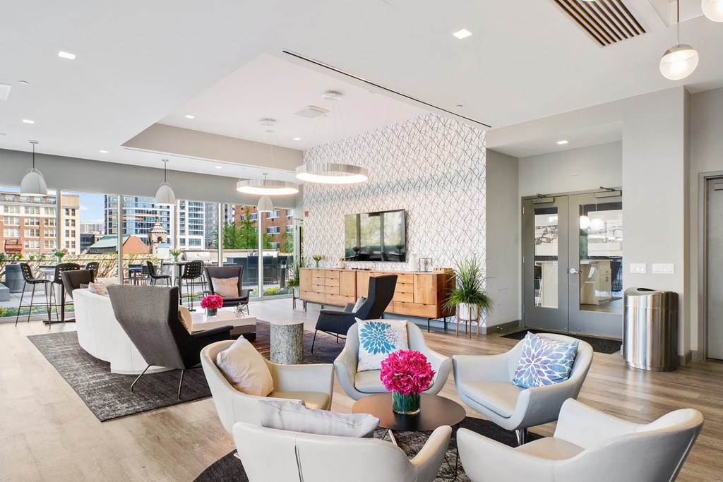 a living room filled with furniture and a large window