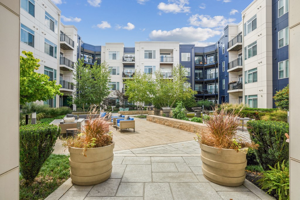 an outdoor patio with potted plants at the bradley braddock road station apartments at Indigo 301 Apartments, Pennsylvania, 19406