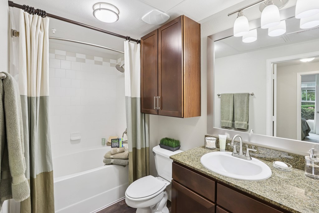 A bathroom with a toilet, sink, and shower.