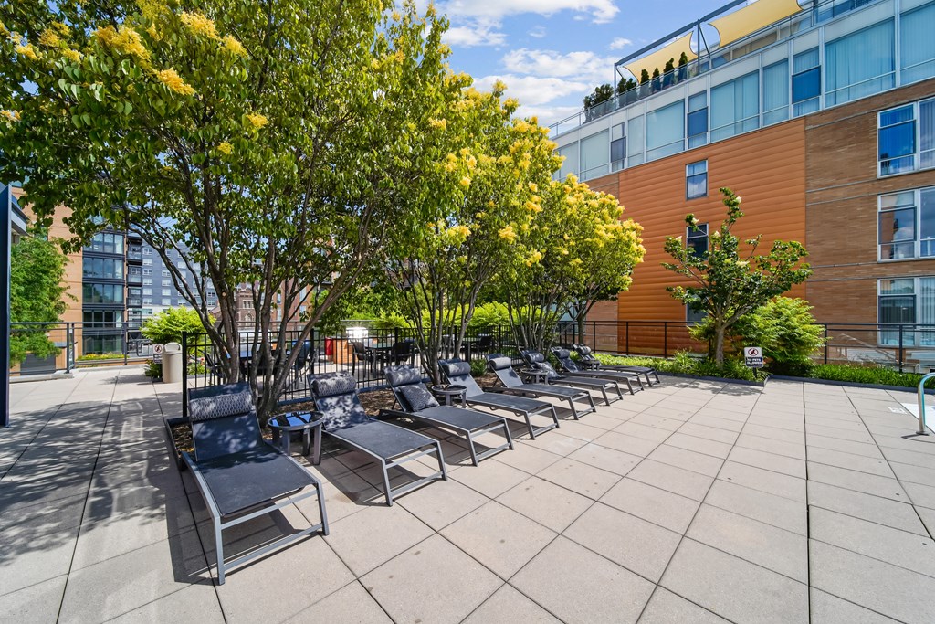A sunny day at the outdoor seating area of a modern building.