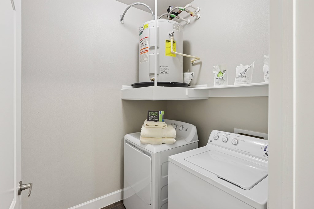 A white washing machine and dryer in a small laundry room.