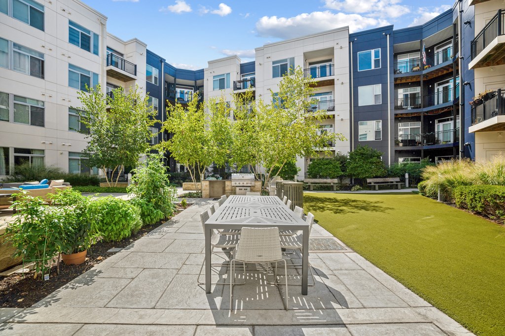 a patio with a table and chairs in front of an apartment building at Indigo 301 Apartments, Pennsylvania, 19406
