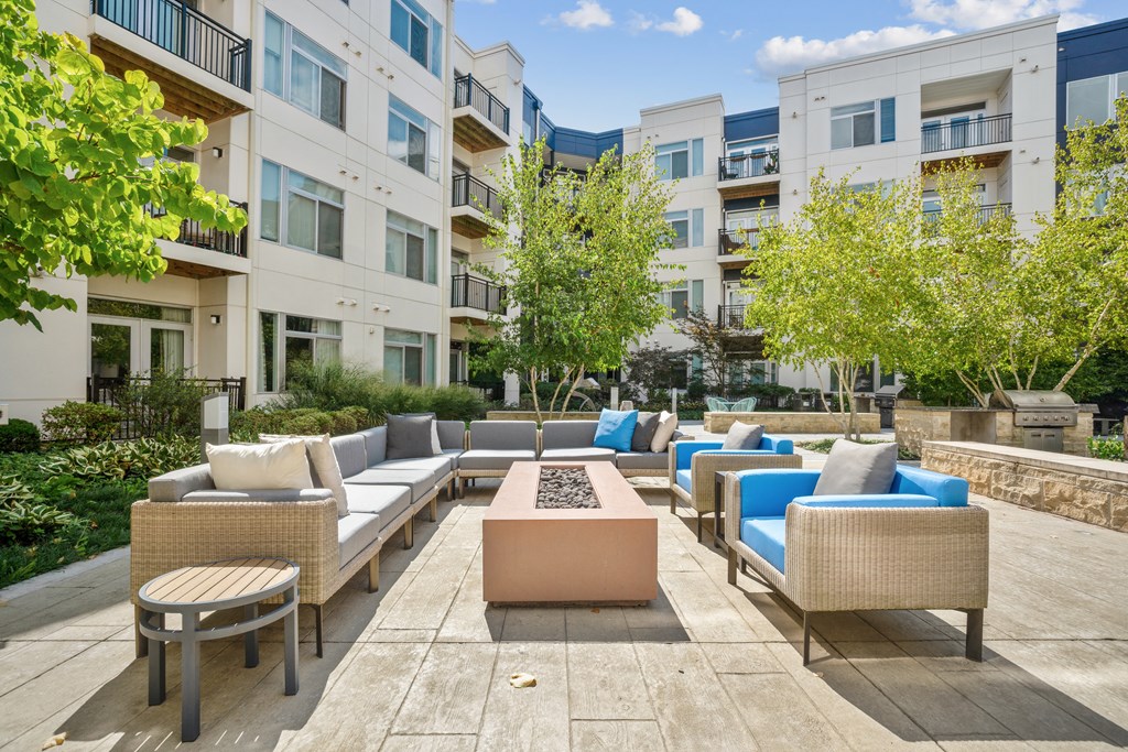 a seating area with couches and a fire pit in front of an apartment building at Indigo 301 Apartments, Pennsylvania, 19406
