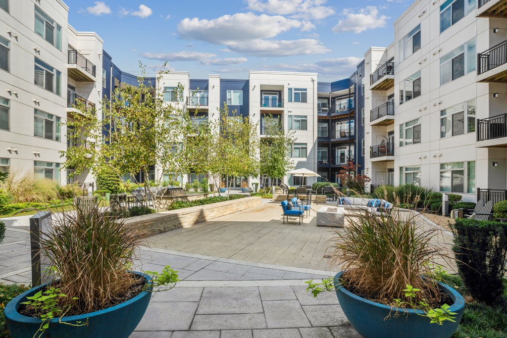 an outdoor patio with a firepit and seating at the bradley braddock road station at Indigo 301 Apartments, Pennsylvania, 19406