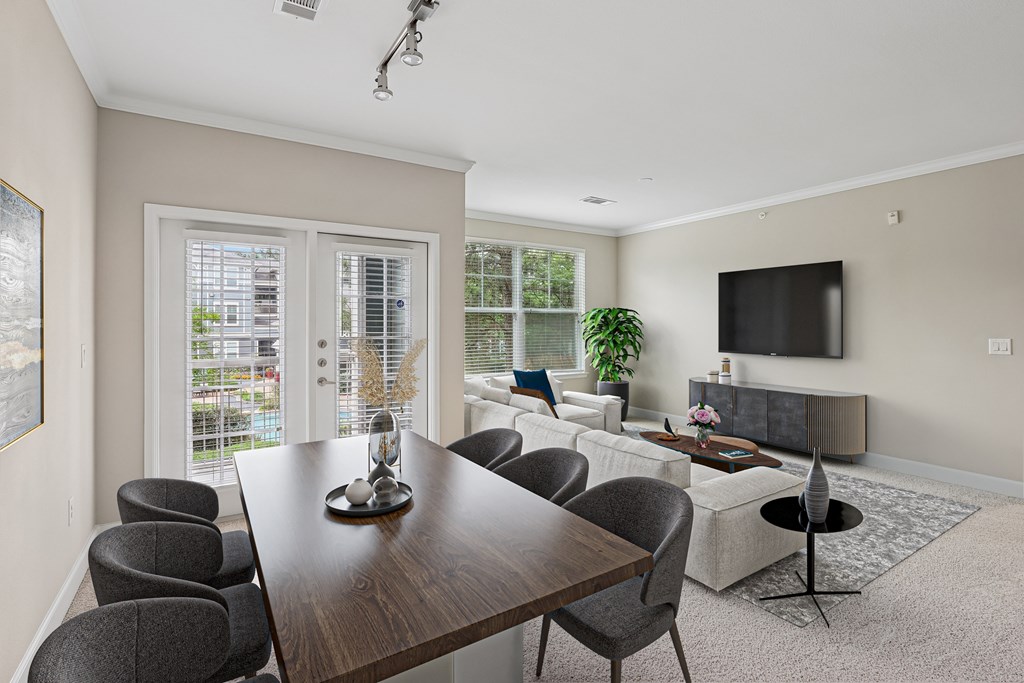 A modern dining room with a wooden table and grey chairs.