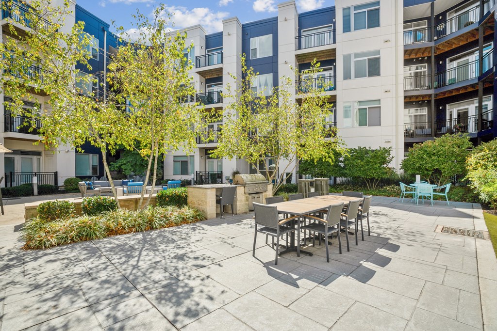 a patio with a table and chairs in front of an apartment building at Indigo 301 Apartments, Pennsylvania, 19406