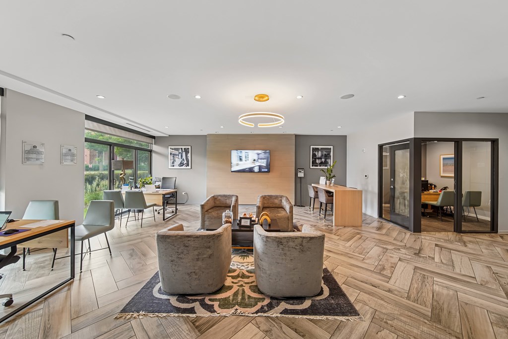 A modern living room with a flat screen TV and a wooden floor.