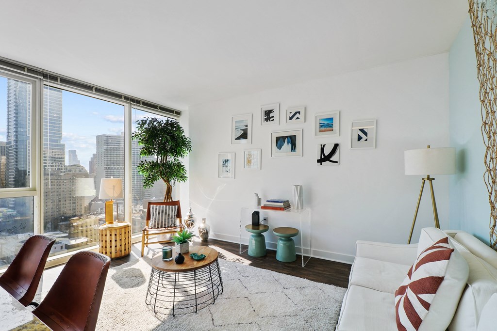 a living room with a white couch and a large window