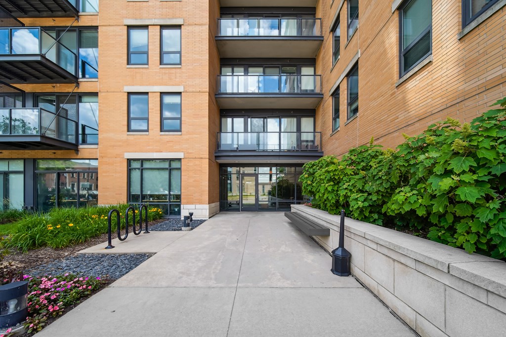 A modern building with a concrete walkway in front.