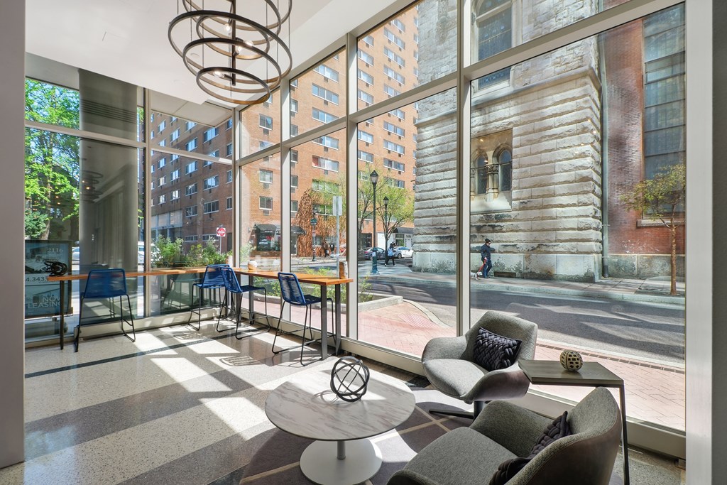 a lobby with chairs and a table with a sculpture on top of it