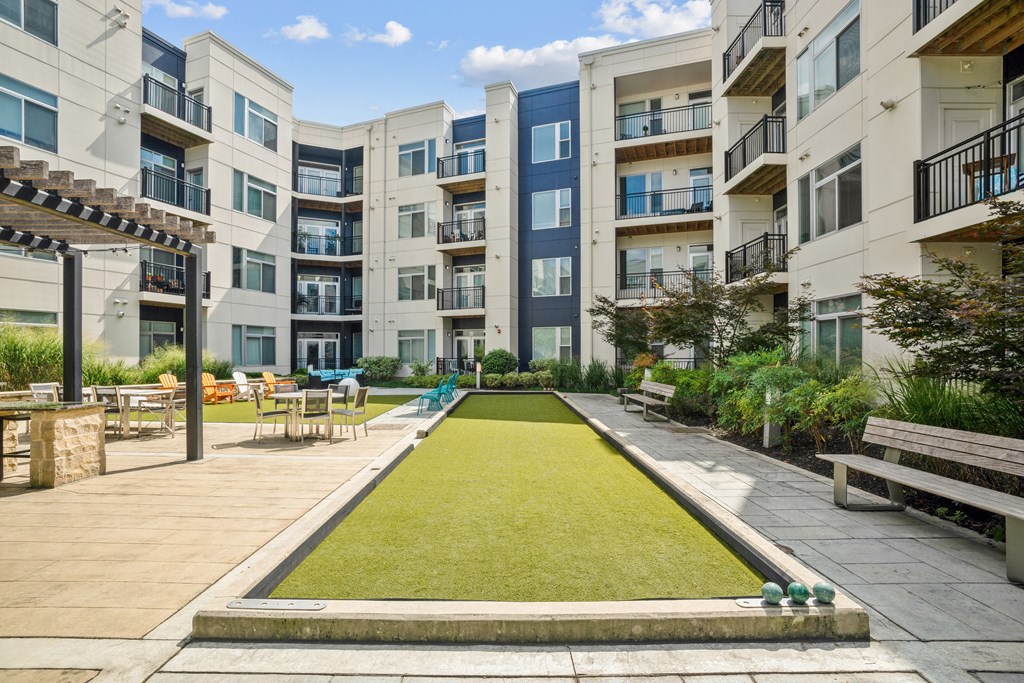 a grassy area with benches and tables in front of an apartment building at Indigo 301 Apartments, Pennsylvania, 19406