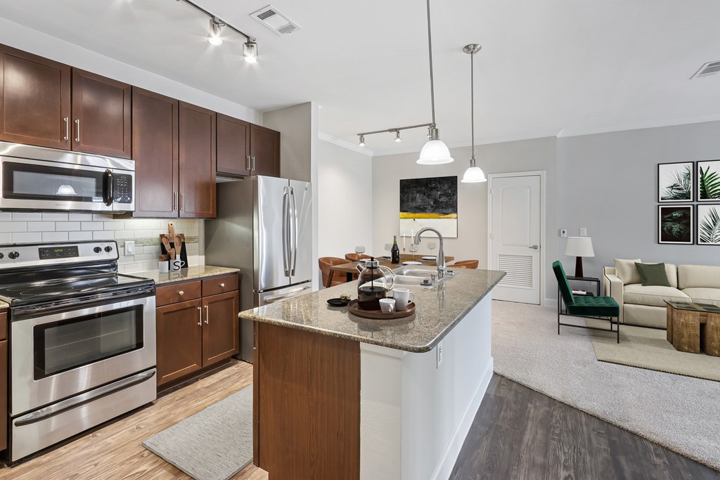 A modern kitchen with a stainless steel stove and refrigerator.