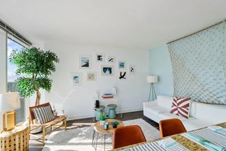 a living room with a white couch and a large window