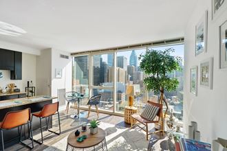 a living room with a large window and a view of the city