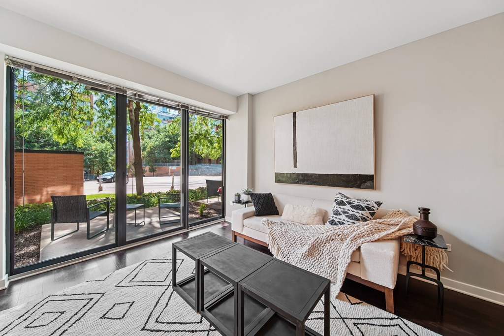 A living room with a couch, coffee table, and sliding glass doors.