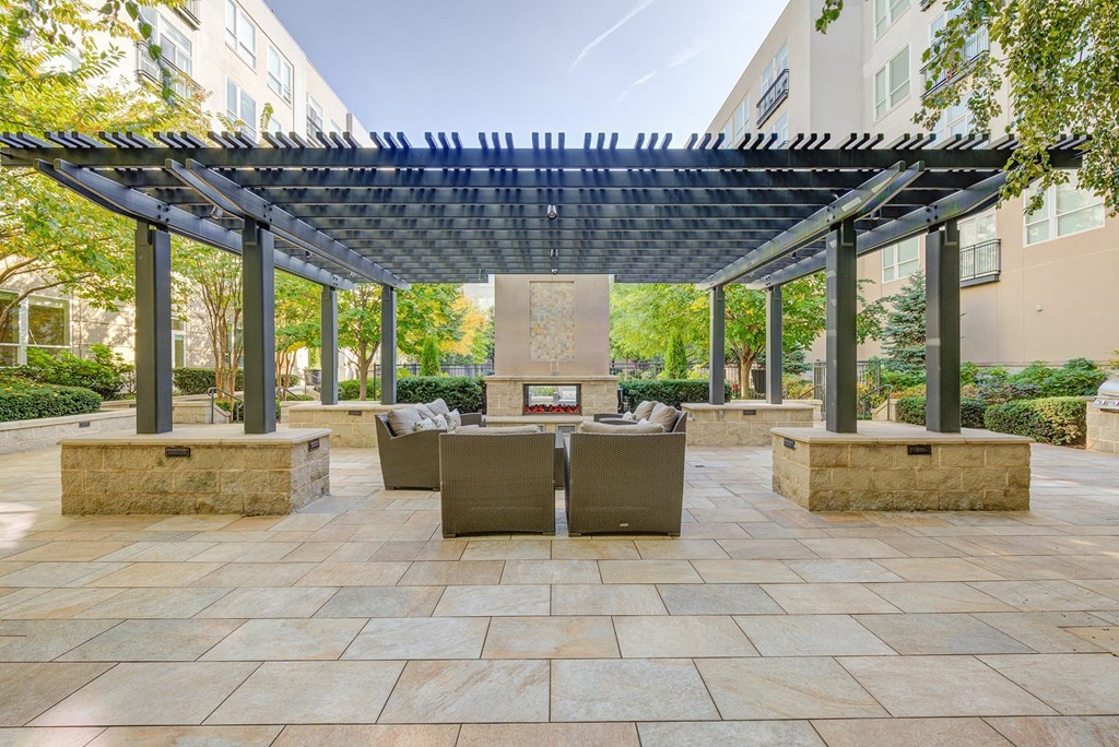 a patio with a table and chairs under a pergola