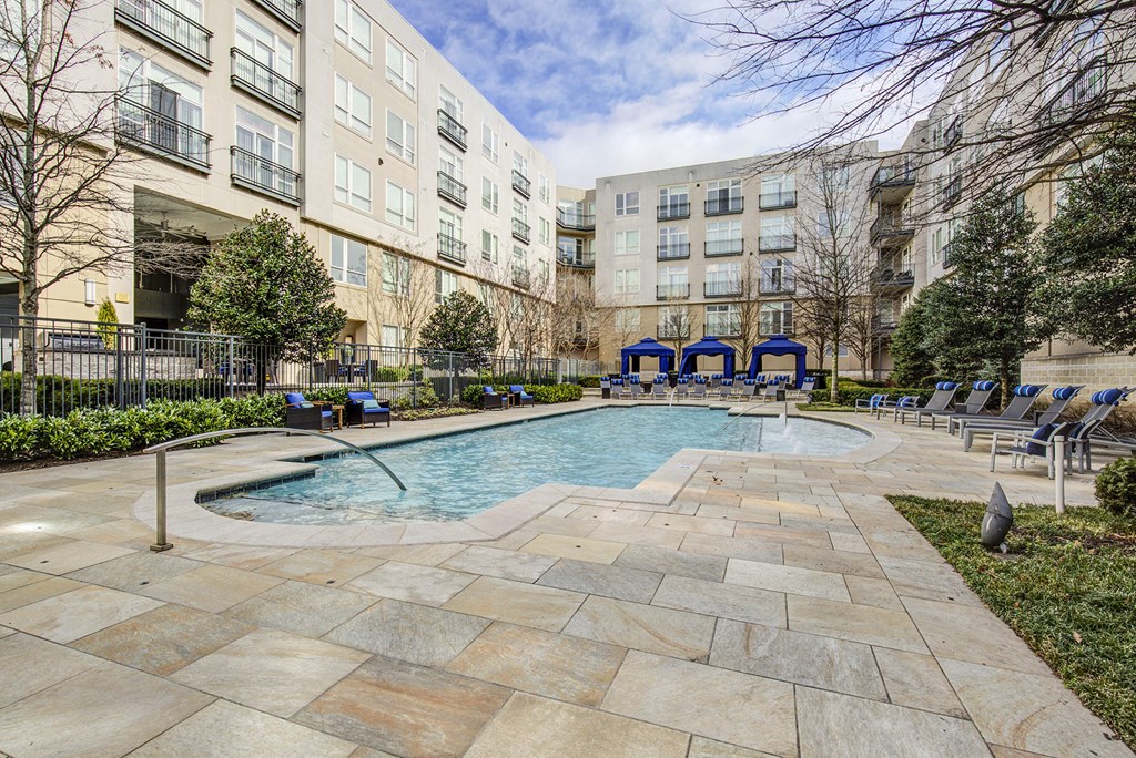 a swimming pool in a courtyard with an apartment building