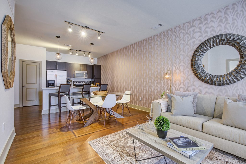 a living room with a couch and a dining room table