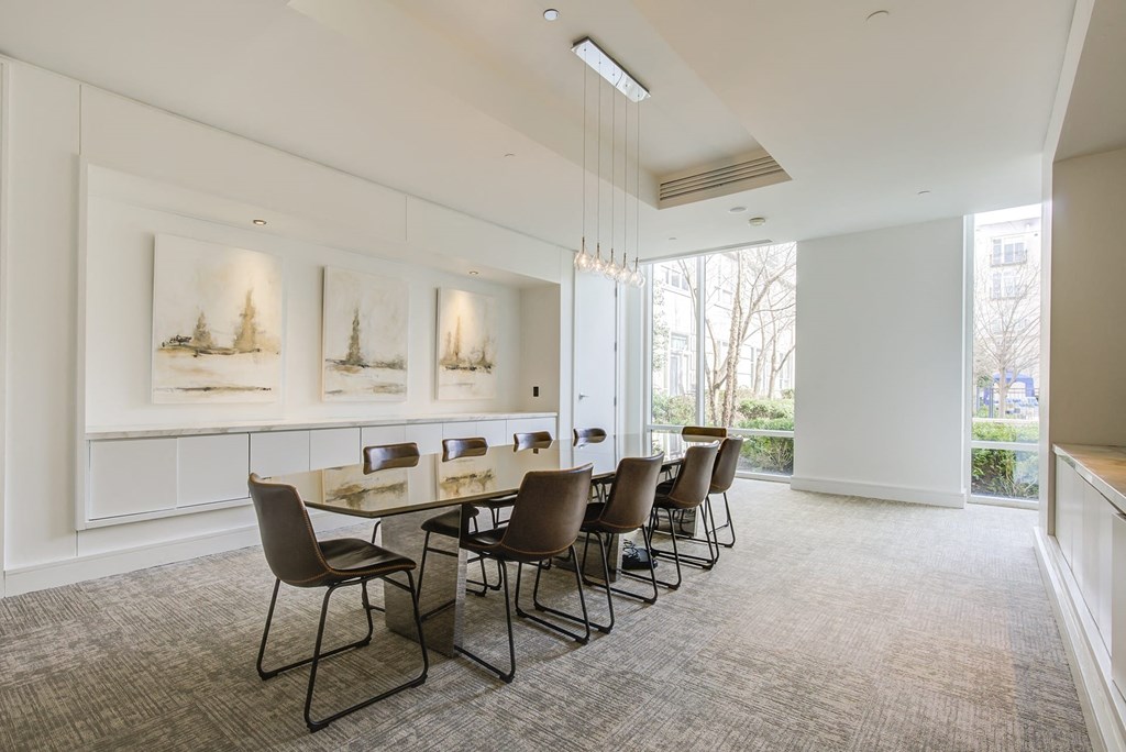 a conference room with a long table and chairs and a large window