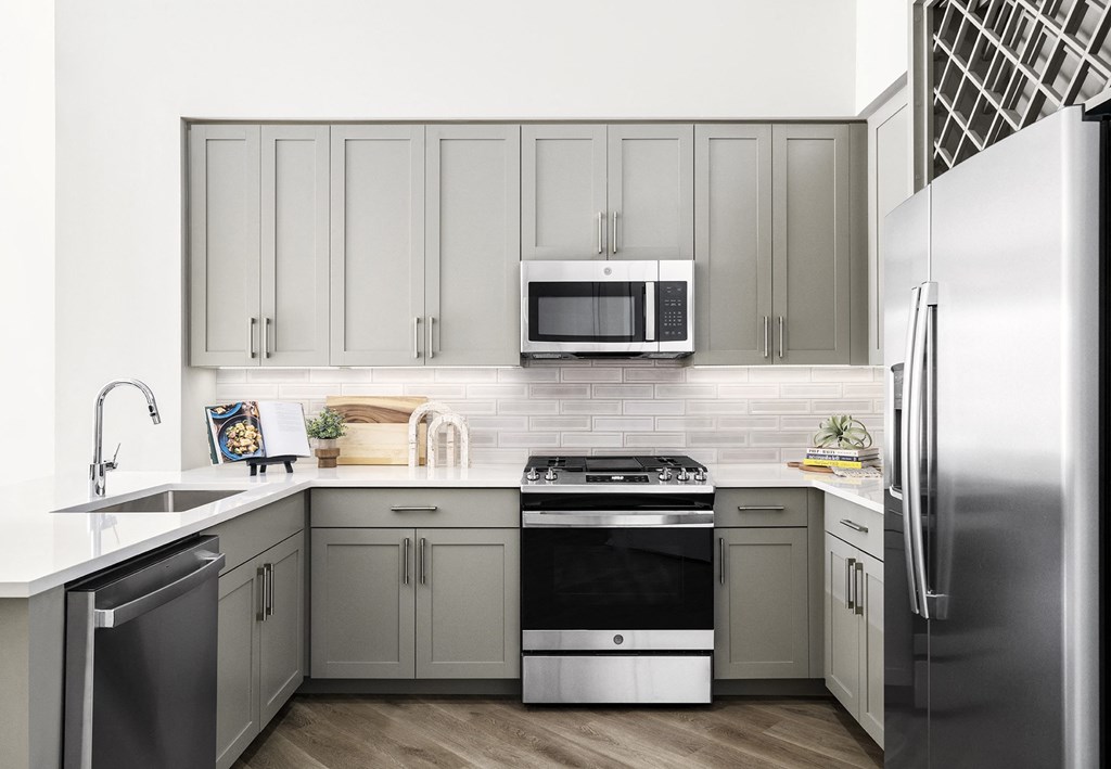 a kitchen with stainless steel appliances and white cabinets at The Ivy, Chatham, NJ