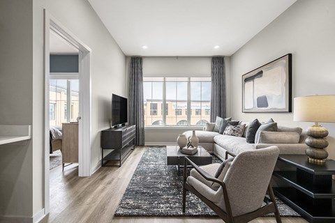 a living room with a couch and a tv at The Ivy, New Jersey