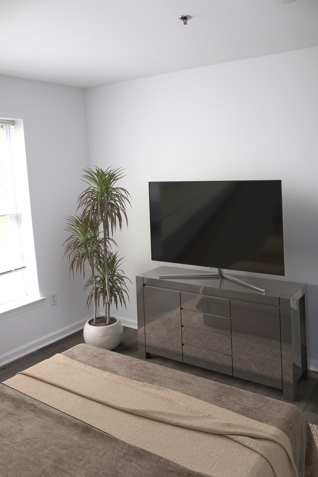 a bedroom with a bed and a television in the corner