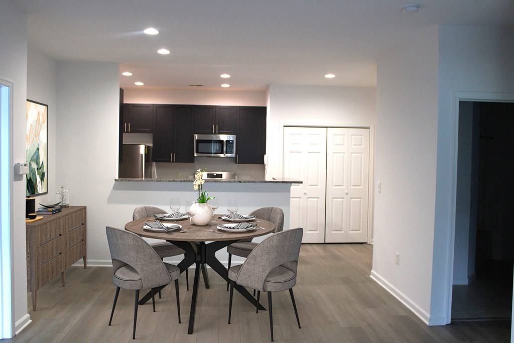 a kitchen and dining room with a table and chairs