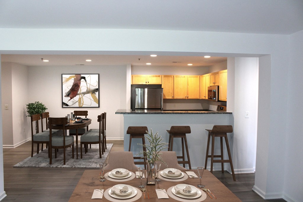 a dining room and kitchen with a table and chairs