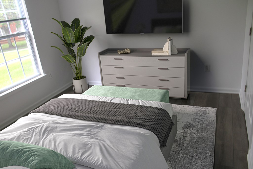 a bedroom with a bed and a dresser with a tv